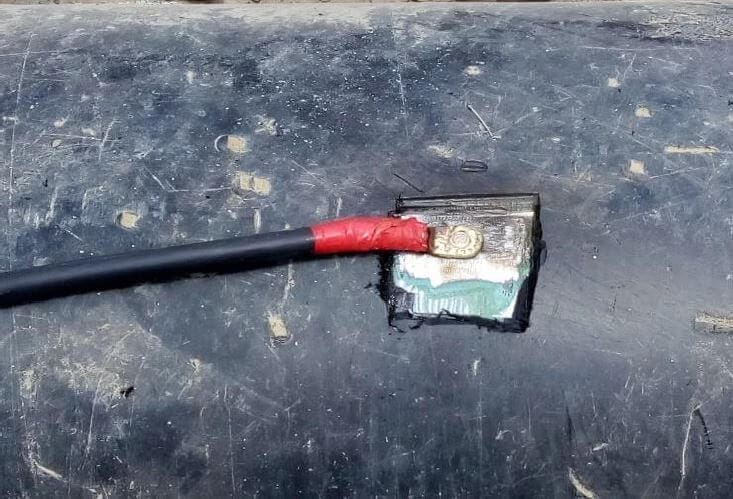 Red-insulated cable crimped to metal terminal