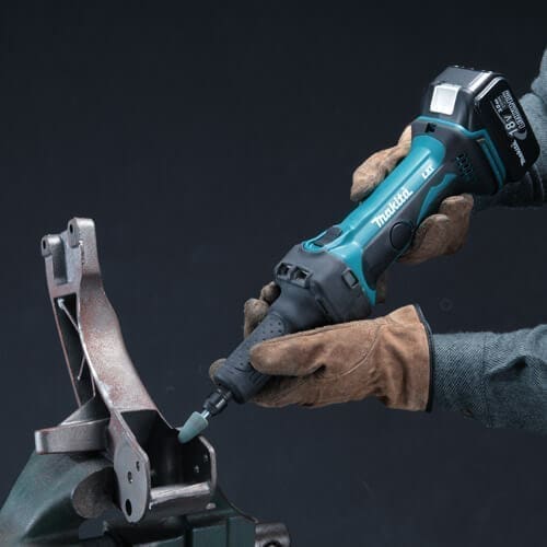 Gloved hands using Makita cordless rotary tool
