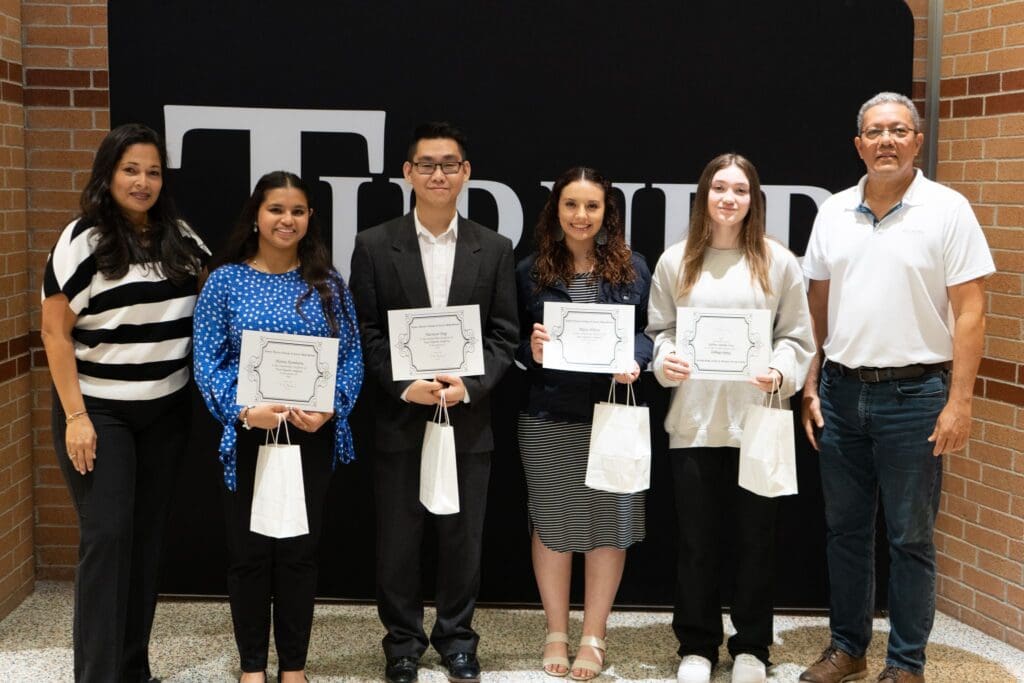 Students holding certificates and gift bags