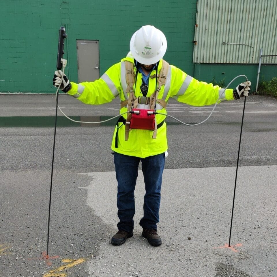 Utility line locator in high-visibility jacket